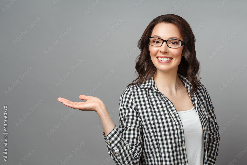 Young woman smiling and gesturing to copy space. Young woman smiling and gesturing to copy space.