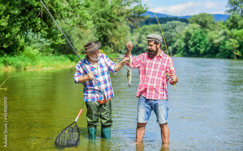 Mature man with friend fishing. It is not sport, it is obsession. Bearded men catching fish. Summer vacation. Fisherman with fishing rod. Activity and hobby. Fishing freshwater lake pond river