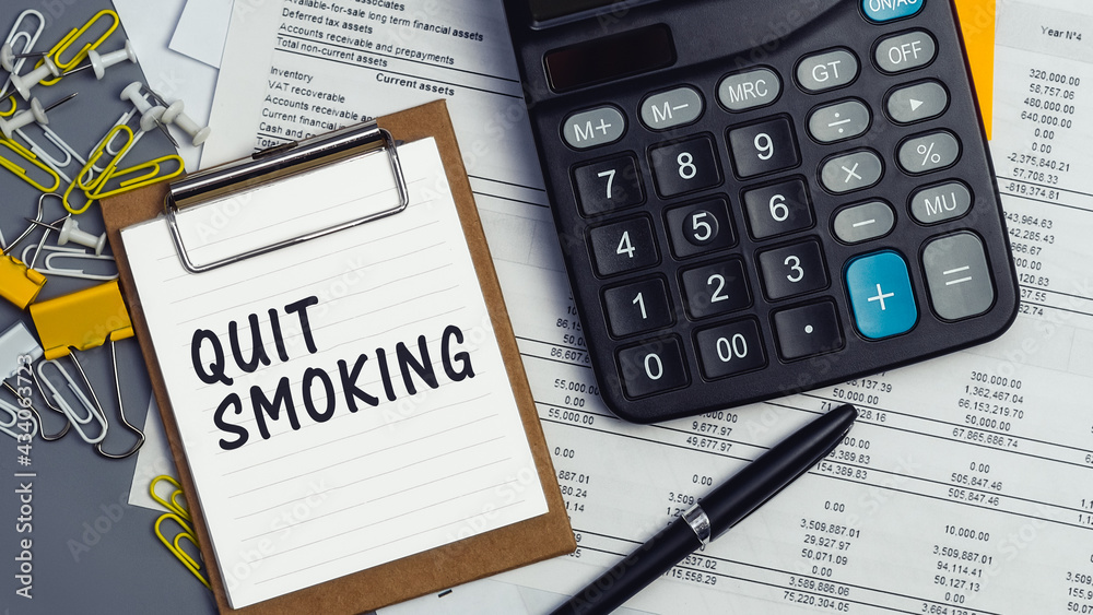 The words Quit Smoking written on a white notebook The words Quit Smoking written on a white notebook