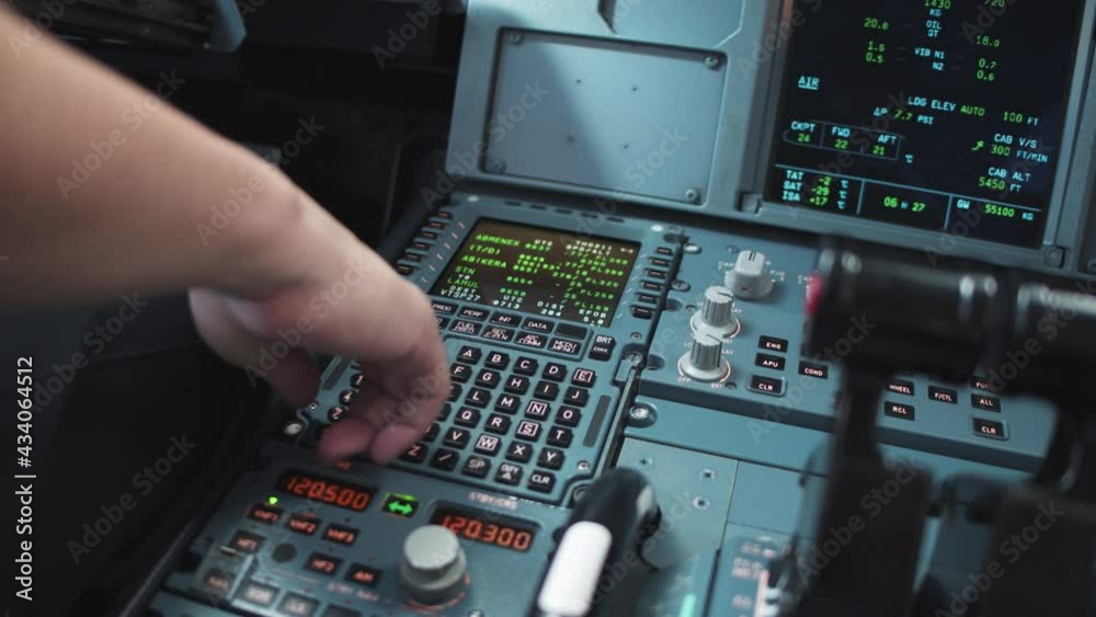 Pilot's hand controls the modern airplane. Pilot inputting parameters to the computer of airplane. The MCDU system of airplane-Airbus system.4K