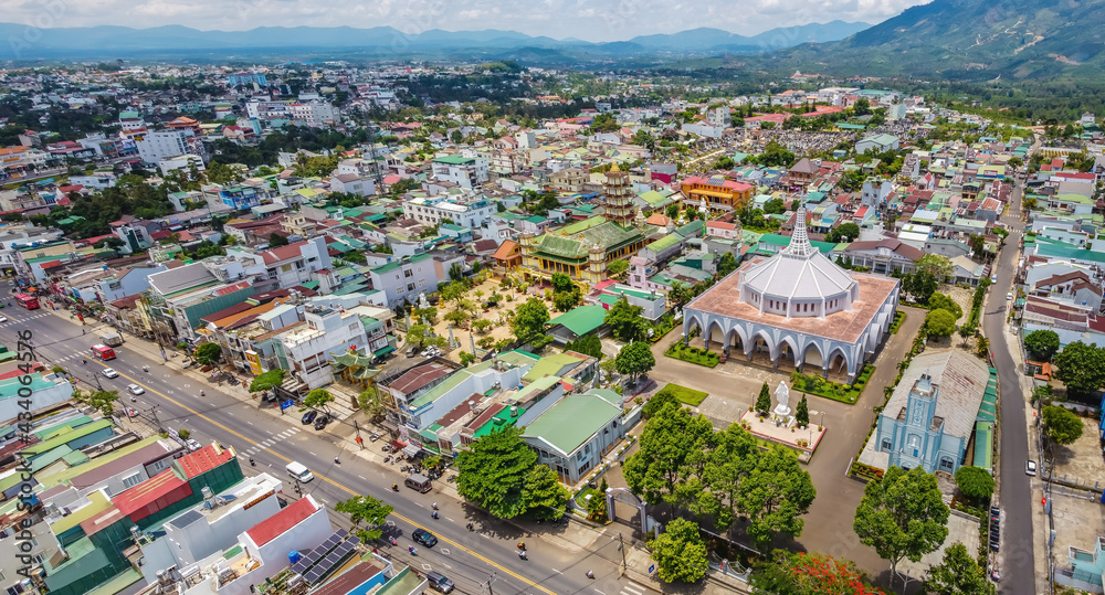 Aerial view of ancient Phuoc Hue pagoda is next to Bao Loc church on summer's day in Bao Loc, Vietnam, peaceful small town located on the plateau Di Linh, Lam Dong province.