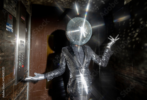Mr disco ball dancing in a lift