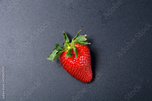 Strawberries on a gray matte background.