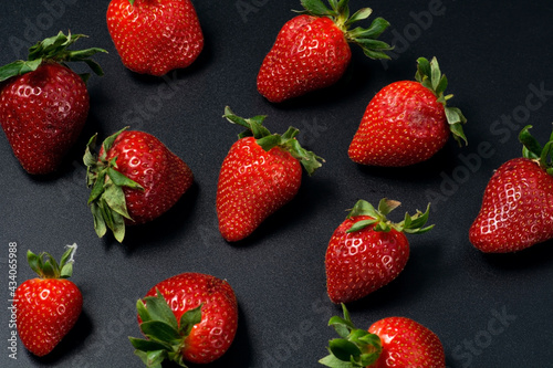 Juicy strawberries on a black background.