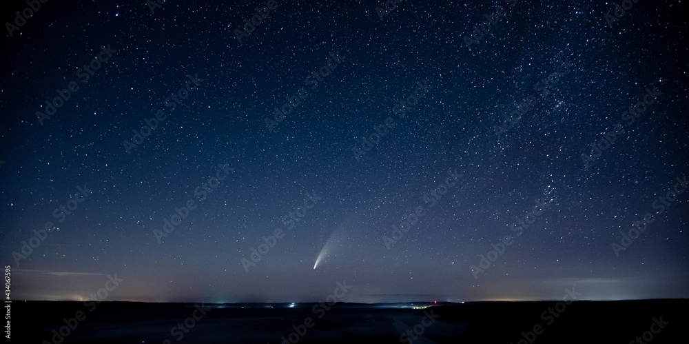 Wonderful view of starry sky and C/2020 F3 (NEOWISE) comet with light tail.