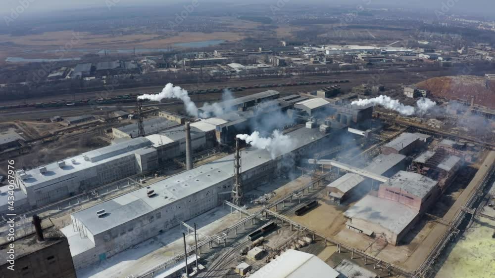 Pipe factory smoke. Aerial survey. Emission to atmosphere from industrial pipes. Smokestack pipes shooted with drone. Aerial view of industrial area with chemical plant. Smoking chimney from factory. Pipe factory smoke. Aerial survey. Emission to atmosphere from industrial pipes. Smokestack pipes shooted with drone. Aerial view of industrial area with chemical plant. Smoking chimney from factory.
