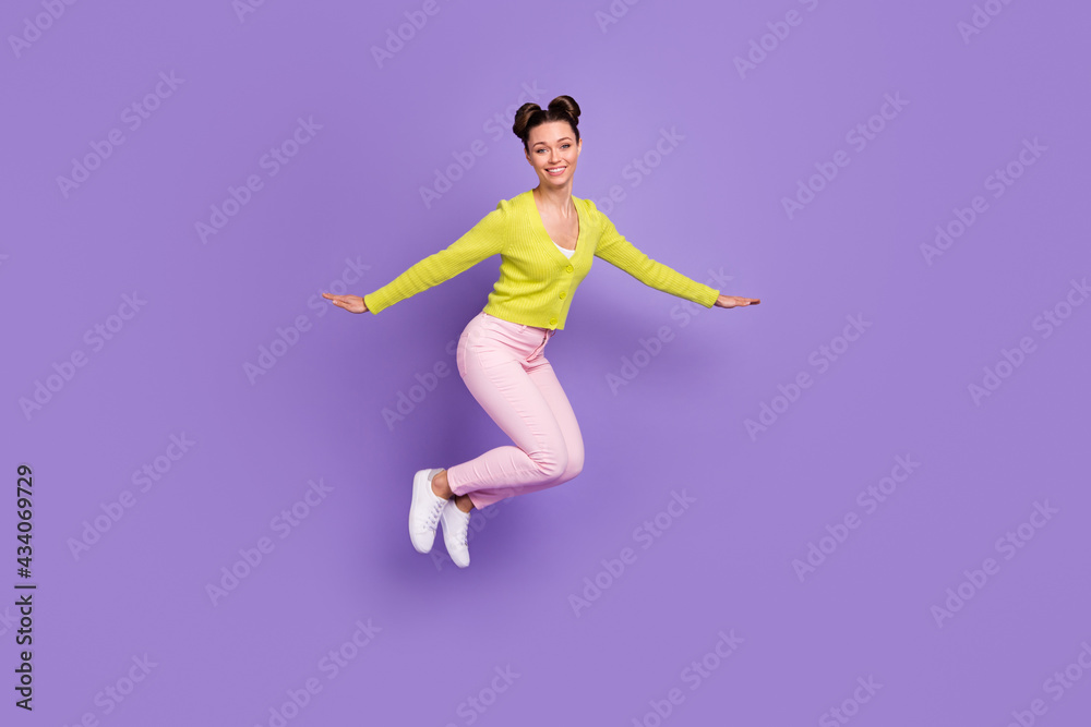 Full size photo of young pretty charming lovely happy smiling positive girl jumping isolated on violet color background