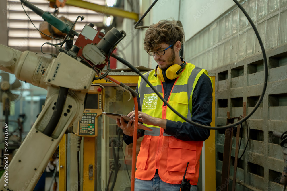 Engineer factory control and checking the robot working in factory workplace. Engineer factory control and checking the robot working in factory workplace.