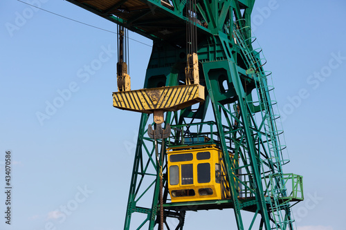 close-up of a gantry crane cabin and a hook with slings. photo