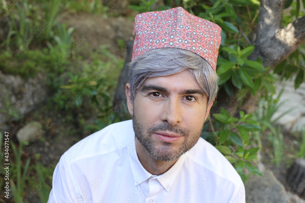 Mature islamic man wearing traditional embroidery hat Mature islamic man wearing traditional embroidery hat
