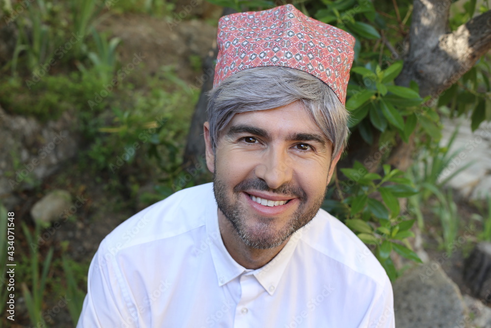Mature islamic man wearing traditional embroidery hat Mature islamic man wearing traditional embroidery hat