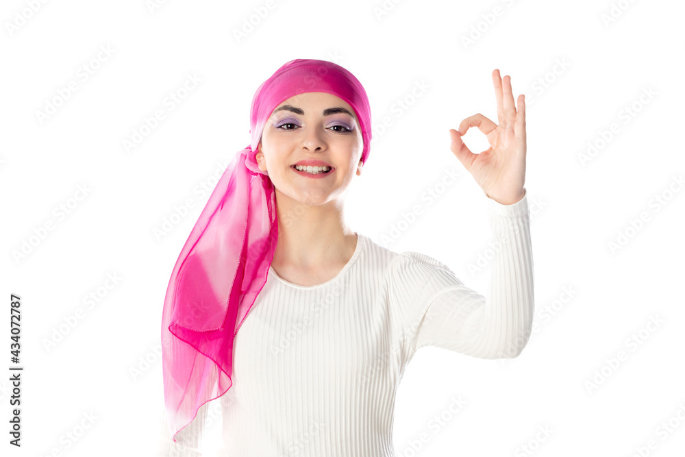 Young brunette woman wearing pink head scarf Young brunette woman wearing pink head scarf