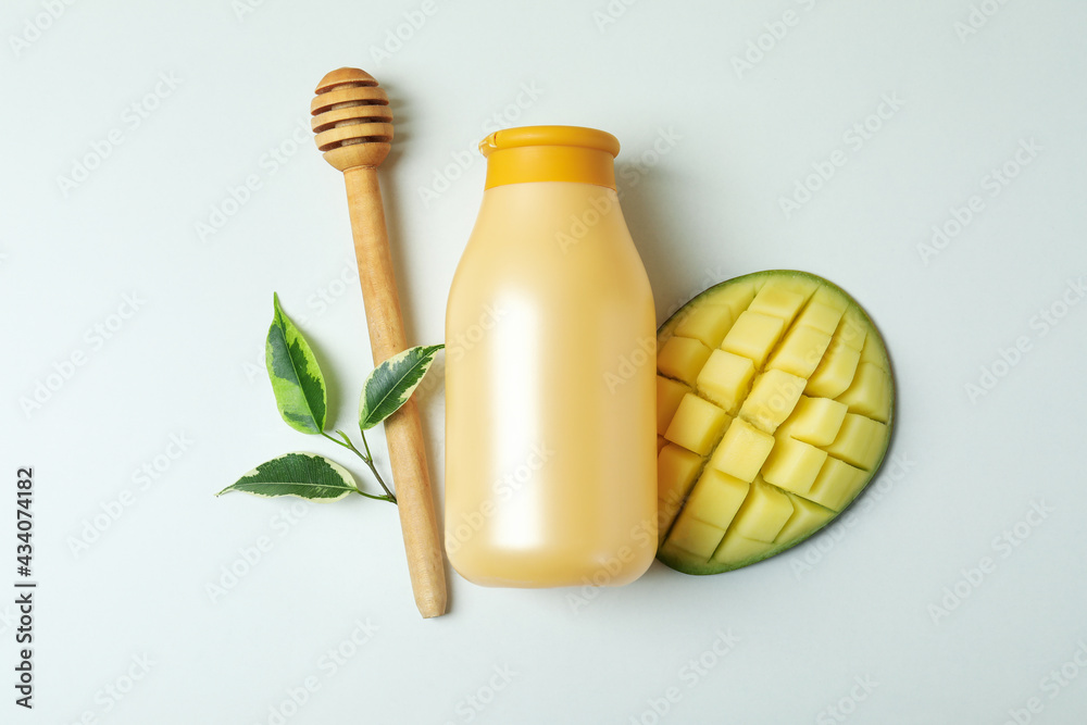 Shower gel, mango and dipper on white background Shower gel, mango and dipper on white background