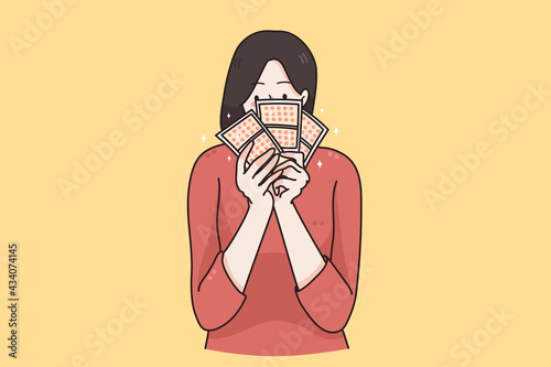 Trying chances in lottery concept. Portrait of emotional young woman cartoon character standing alone with with lottery tickets on yellow background vector illustration 