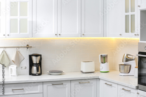 Modern toaster and other cooking appliances on countertop in kitchen