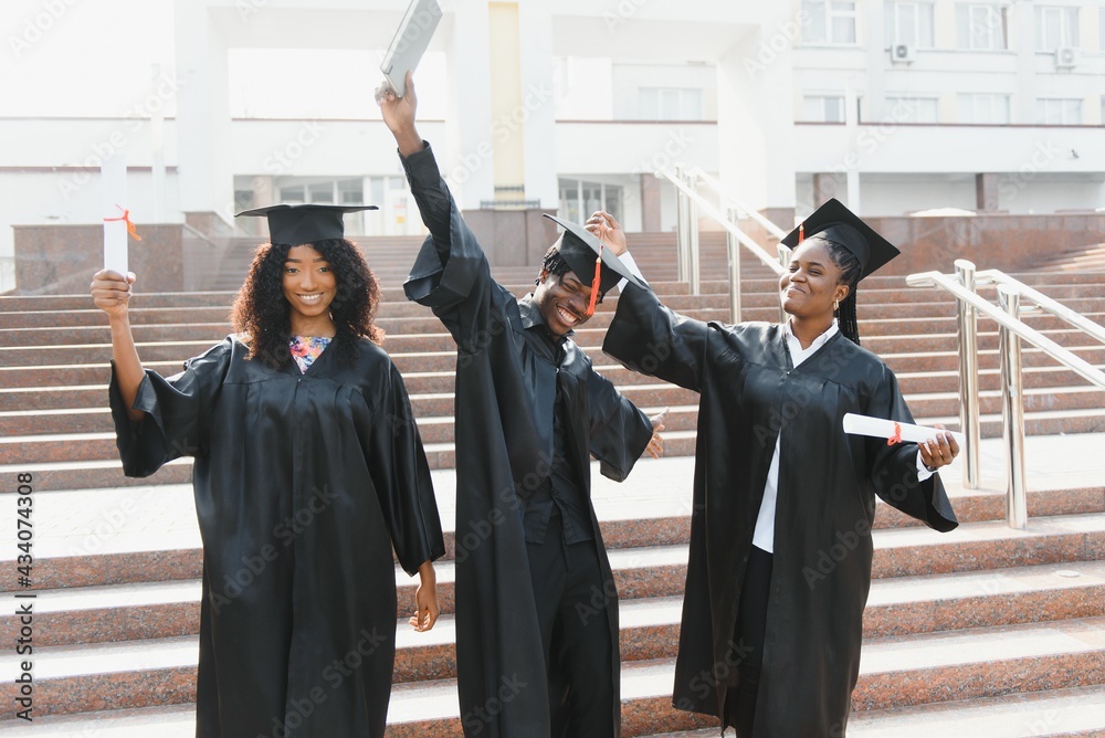 © Serhii - education, graduation and people concept - group of happy international students in mortar boards and bachelor gowns with diplomas © Serhii - education, graduation and people concept - group of happy international students in mortar boards and bachelor gowns with diplomas