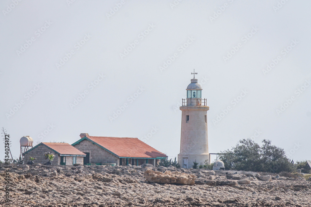 Lighthouse and lighthouse keeper's house on the coast in Cyprus