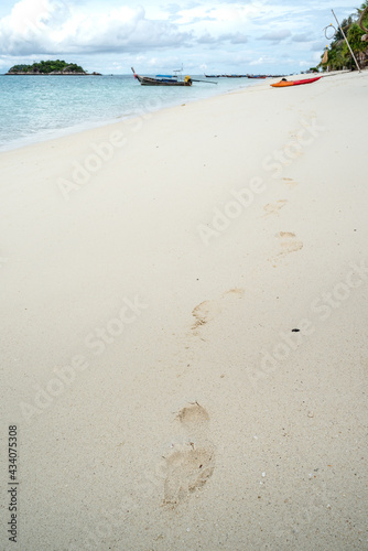 footprints on the beach that tracking someone walking from kayak