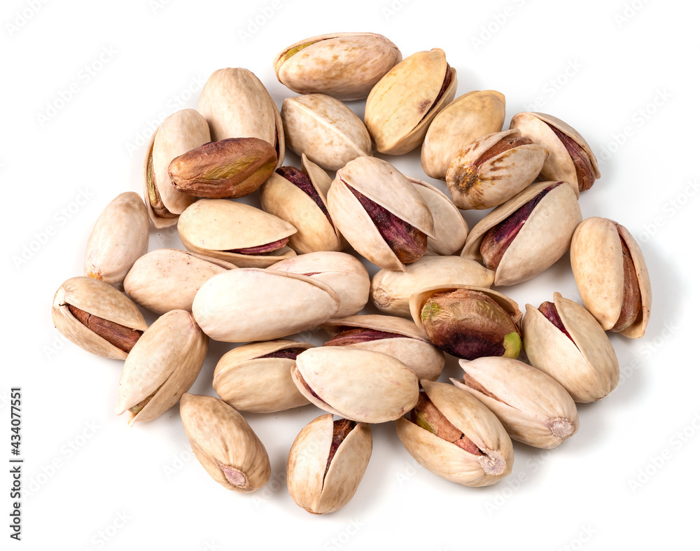 pile of ripe pistachio nuts closeup on white pile of ripe pistachio nuts closeup on white