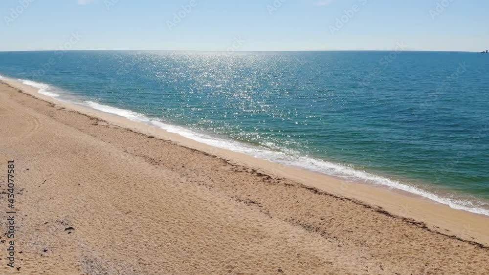 Aerial top view of ocean blue waves crashing on the beach. Sea waves and beautiful sandy beach aerial view shot from a drone. Aerial top view of ocean blue waves crashing on the beach. Sea waves and beautiful sandy beach aerial view shot from a drone.