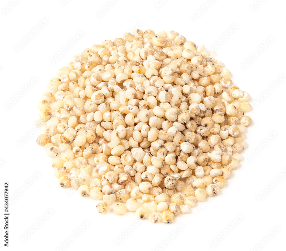 pile of raw Sorghum groats closeup on white pile of raw Sorghum groats closeup on white