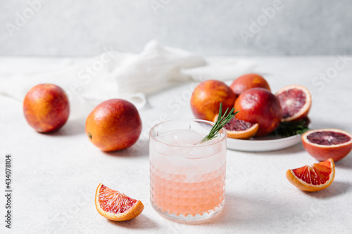 Blood orange vodka soda cocktail on white table background. Summer cocktails, lemonade, refreshing drinks, cocktail party concept. Copy space