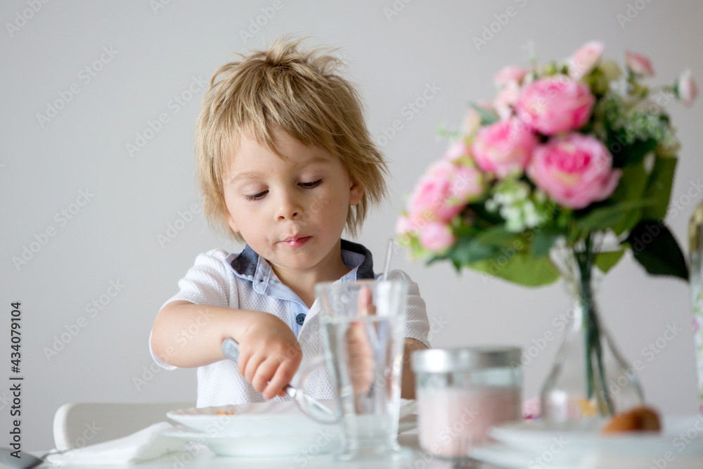 Sweet toddler boy, drinking water at home