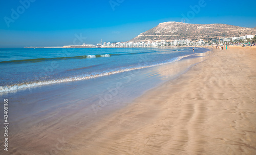 Agadir beach on the Atlantic African coast in the summertime with yellow sand and turquoise water in Morocco photo