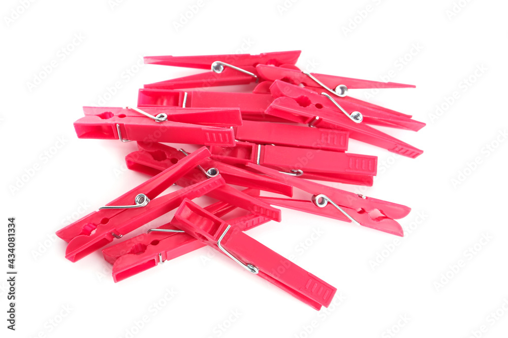 Bright pink plastic clothespins on white background, above view Bright pink plastic clothespins on white background, above view