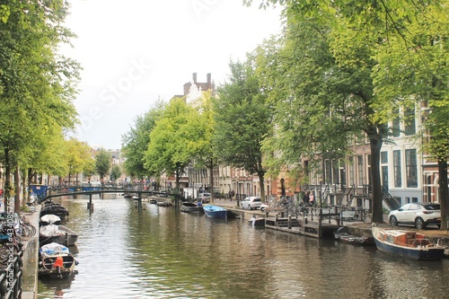 Canal in Amsterdam. Boats, water, trees, reflections. 