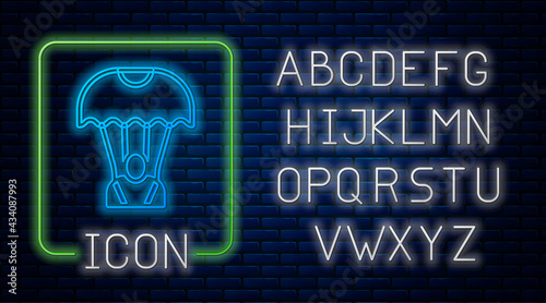 Glowing neon Parachute icon isolated on brick wall background. Neon light alphabet. Vector