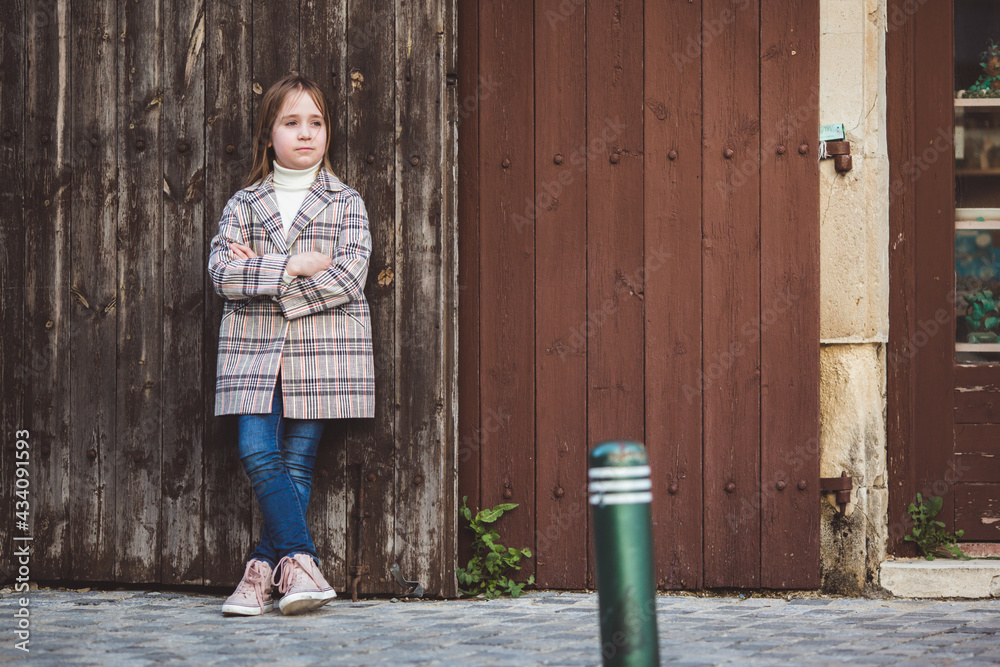 Portrait of adorable little fashionable girl outdoors near old fence Portrait of adorable little fashionable girl outdoors near old fence