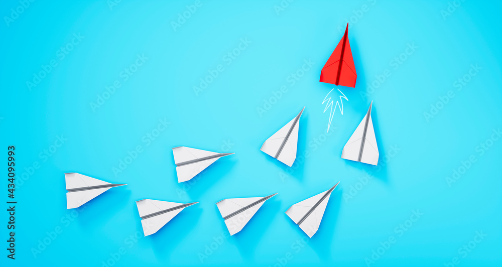 Group of paper airplanes with red leader plane on blue background
Group of paper airplanes with red leader plane on blue background