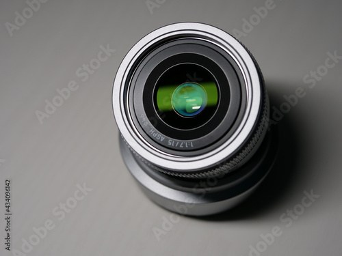 Silver metal prime lens with green light on the front lens group
