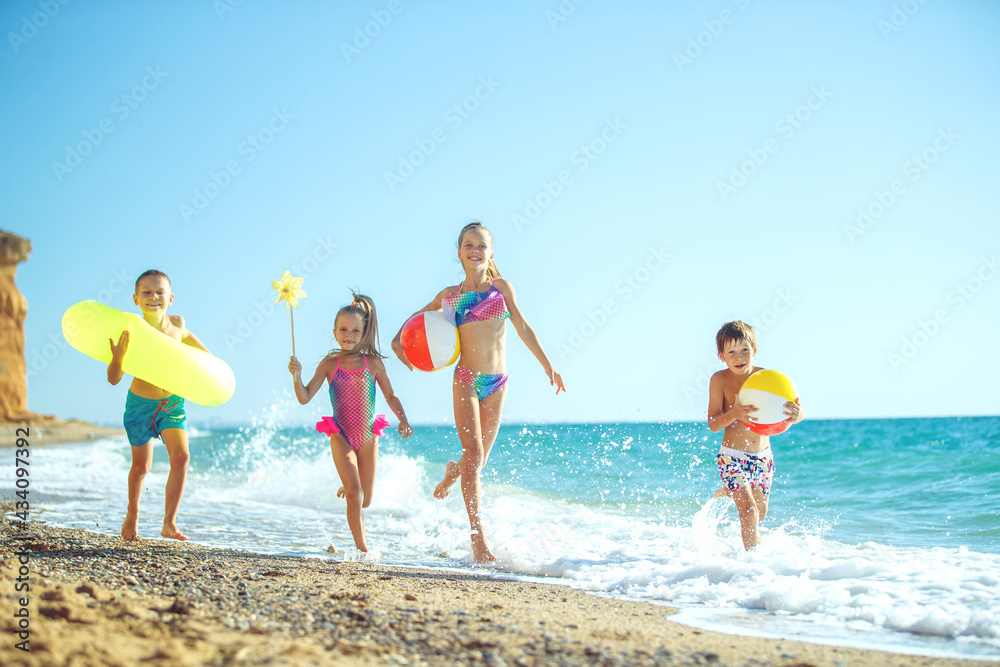 Cute children enjoying sunny day at beach. Summer camp. High quality photo