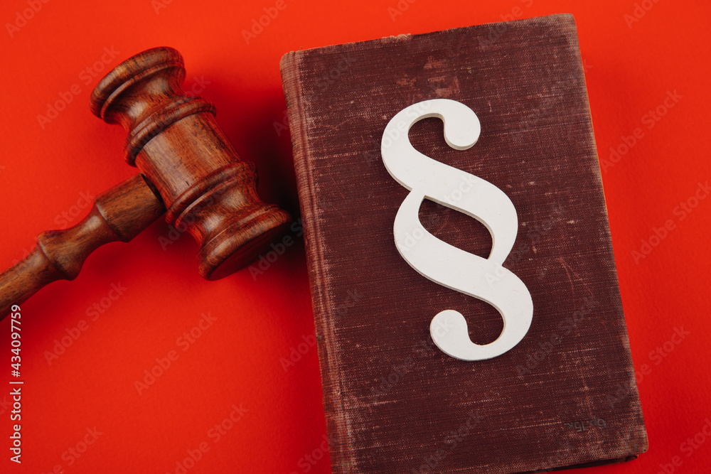 Paragraph symbol and gavel on red. Law and justice concept