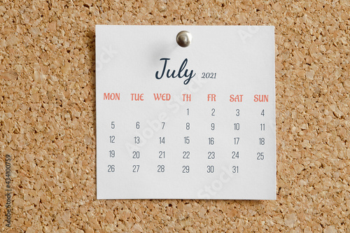 Page from calendar for full month: June 2021. White sheet with dates is pinned to cork board. Concept of calendar date photo