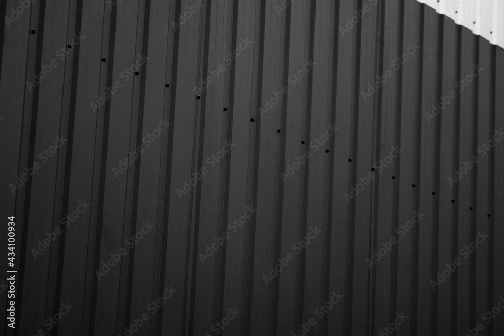 Black corrugated iron sheet used as a facade of a warehouse or factory