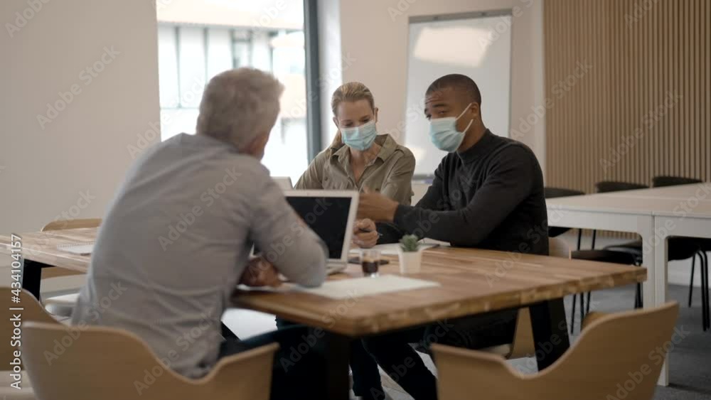 Business people in modern meeting room working together on project Business people in modern meeting room working together on project