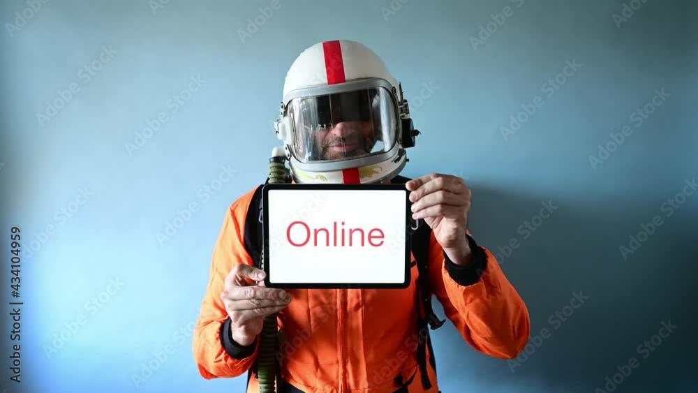 Astronaut man showing a tablet that says ONLINE Astronaut man showing a tablet that says ONLINE