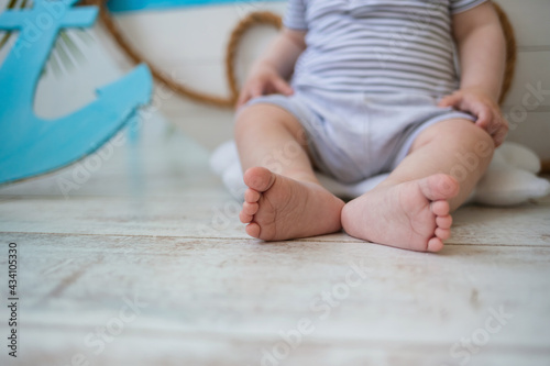 close-up of a child's bare feet on a wooden floor with room for text