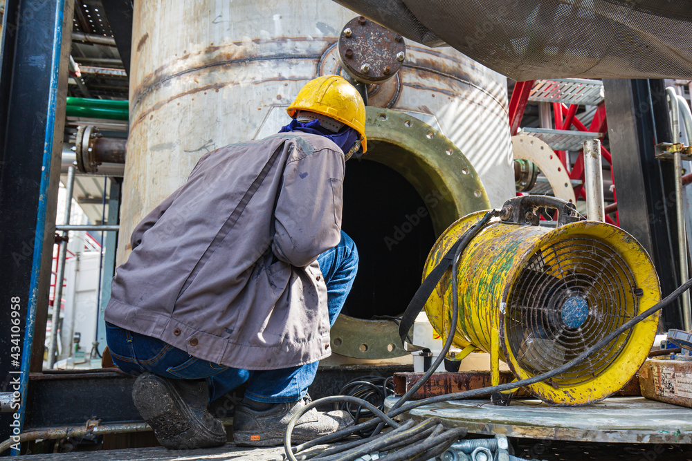 Fototapeta premium Male into the tank oil area confined space
