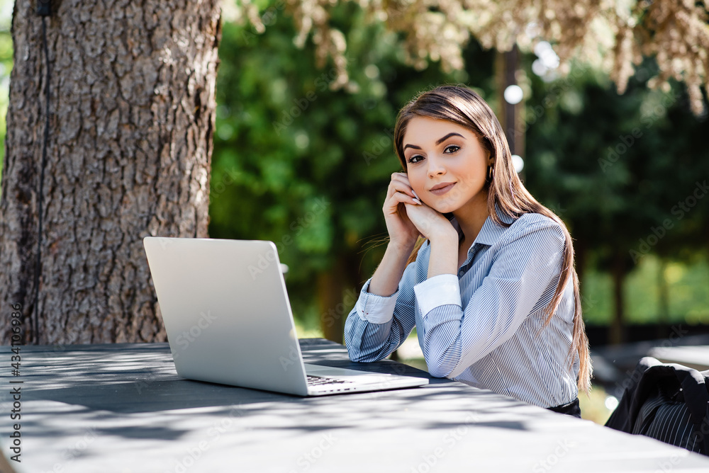 Caucasian businesswoman work on laptop outdoors Caucasian businesswoman work on laptop outdoors