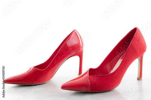 Red high-heeled shoes on a white background