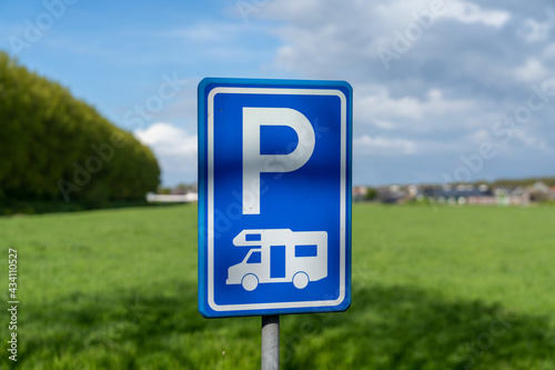 selective focus view of a blue parking lot sign for camper vans and caravans