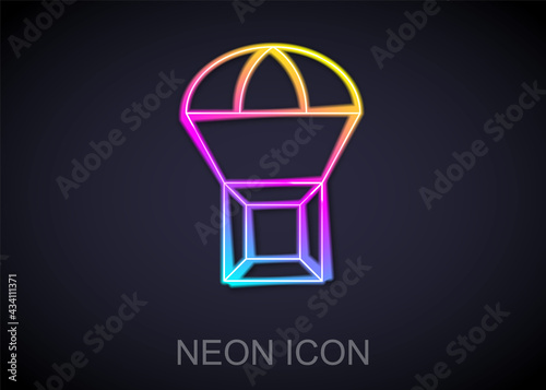 Glowing neon line Box flying on parachute icon isolated on black background. Parcel with parachute for shipping. Delivery service  air shipping. Vector
