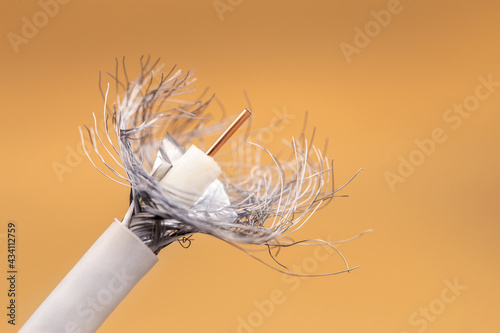 White coaxial wire cable on orange background.