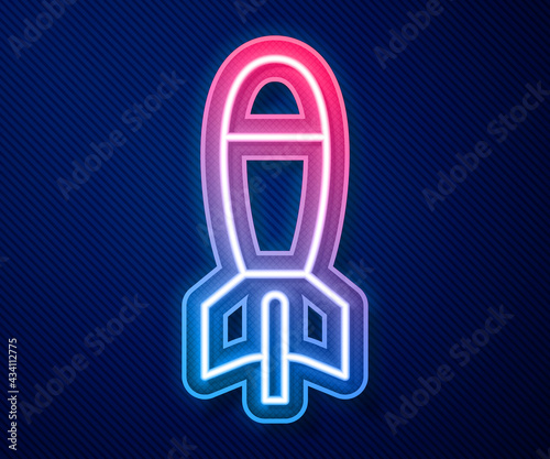 Glowing neon line Rocket launcher with missile icon isolated on blue background. Vector