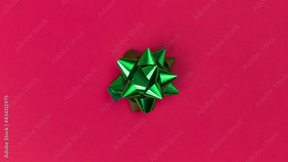 Unwrapping gift revealing a green screen - Stop Motion Animation - Green bow on a red background