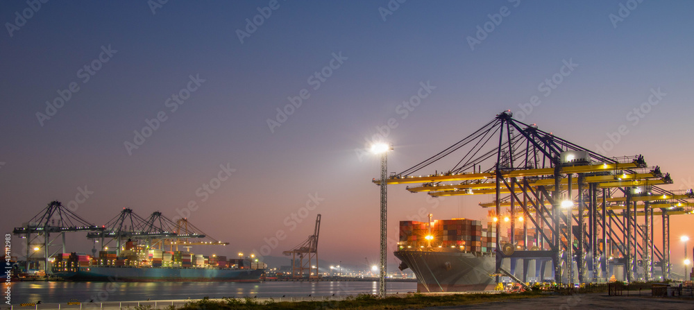 Obraz premium Logistics and transportation of Container Cargo ship and Cargo plane with working crane bridge in shipyard at sunrise, logistic import export and transport industry background